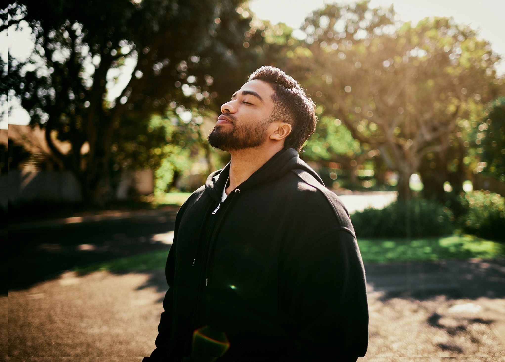 Man breathing fresh air outdoors in a calm park setting